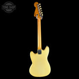 A Fender electric guitar shown from the back, featuring a pale yellow body and a natural wood neck, set against a solid black background with a Tone Shop watermark in the top left corner.