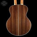 Wooden acoustic guitar back with 'Tone Shop' logo in the corner