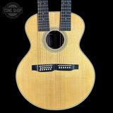 Acoustic guitar with a visible brand logo on a black background