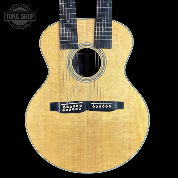 Acoustic guitar with a visible brand logo on a black background