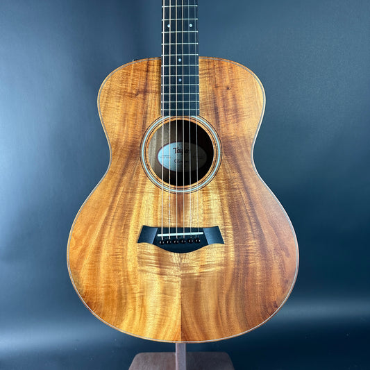 Acoustic guitar with a wooden finish on a dark blue background