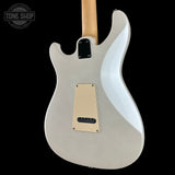 The back of a white electric guitar with a maple neck, shown against a solid black background. A Tone Shop watermark is visible in the top-left corner.