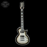 Electric guitar with a black and white pattern on a black background, featuring 'Tone Shop' logo.