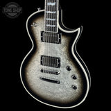 Electric guitar with a textured finish on a black background, featuring the Tone Shop logo.