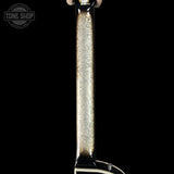 Close-up of a guitar pickup with a black background