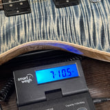PRS Wood Library Custom 24 Stoptail Limited Edition Faded Whale Blue Stained Neck on scale displaying weight.