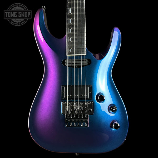 Blue and purple electric guitar on a black background with 'Tone Shop' logo.