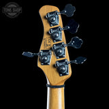 Close-up of a guitar headstock with tuning pegs on a black background, featuring the Tone Shop logo.