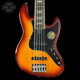 Electric bass guitar with a sunburst finish on a black background, featuring the Tone Shop logo.