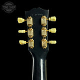 Guitar headstock with tuning pegs on a black background, featuring 'Tone Shop' logo.