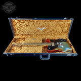Guitar in an open case with a visible brand logo on a black background