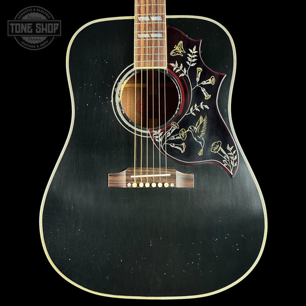 Black acoustic guitar with floral design on a black background, featuring 'Tone Shop' logo.