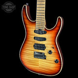 A double-cutaway electric guitar with a natural flame maple top, featuring a vibrant sunburst finish that transitions from a bright orange center to a darker brown edge. The neck is made of a light-colored wood with black fretboard inlays, and the headstock is not visible.
