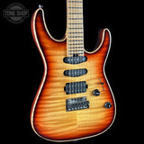 An electric guitar with a natural maple top featuring a vibrant sunburst finish that transitions from bright orange to dark brown. The guitar is shown against a solid black background, with a Tone Shop watermark in the upper left corner.
