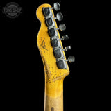 Close-up of a worn guitar headstock with tuning pegs on a black background, featuring the Tone Shop logo.