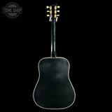 Black acoustic guitar on a black background with 'Tone Shop' logo.