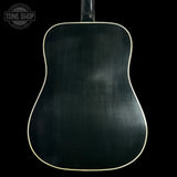 Back view of a black acoustic guitar on a black background with 'Tone Shop' logo.