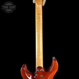 Close-up rear view of an electric guitar showing the maple neck, body, and tailpiece against a black background, with a Tone Shop watermark in the upper left corner.