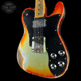 Electric guitar with a sunburst finish on a black background, featuring the Tone Shop logo.