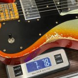Electric guitar on a digital scale displaying weight