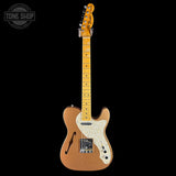 Electric guitar with a blonde finish on a black background, featuring the Tone Shop logo.