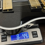 Gibson Custom RD Custom Ebony on scale displaying weight.