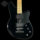 A black electric guitar with a maple neck, chrome hardware, and a white pickguard, shown against a solid black background with a Tone Shop logo in the top left corner.