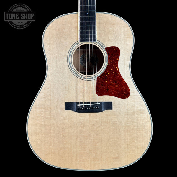 Acoustic guitar with a visible brand logo in the corner