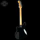 The back view of an electric guitar with a glossy black body, maple neck, and chrome tuning pegs, shown against a solid black background with a Tone Shop watermark in the top-left corner.