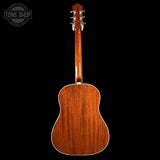 Back view of a wooden acoustic guitar on a black background with 'Tone Shop' logo.