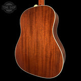Back view of a wooden acoustic guitar with 'Tone Shop' logo in the corner.