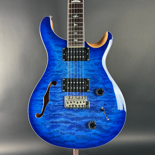 Blue electric guitar on a gray background