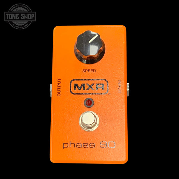 Orange MXR phase 90 guitar effects pedal with a black background