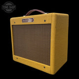 Yellow Fender Champ guitar amplifier with brand logo on a black background