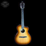 A cutaway acoustic guitar with a natural sunburst finish, shown against a solid black background. A Tone Shop watermark is visible in the top-left corner.