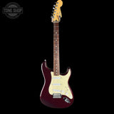 A classic electric guitar with a dark burgundy body, cream pickguard, and maple headstock, shown against a solid black background with a Tone Shop watermark in the top-left corner.