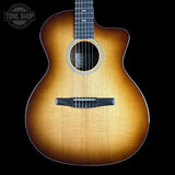 A cutaway acoustic guitar with a natural sunburst finish, shown from the front against a solid black background. A Tone Shop watermark is visible in the top-left corner.