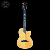 Acoustic guitar with a natural wood finish on a black background, featuring the Tone Shop logo.