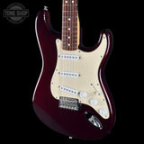 A classic electric guitar with a glossy dark burgundy body, cream pickguard, and chrome hardware, shown against a solid black background with a Tone Shop watermark in the top-left corner.