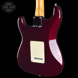 Rear view of an electric guitar with a glossy deep burgundy body, cream pickguard, maple neck, and black hardware, shown against a black background with a Tone Shop watermark in the top left.