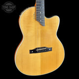 Acoustic guitar with a visible brand logo on a black background