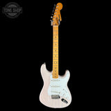 A classic Fender Stratocaster electric guitar with a pale pink/blush finish, maple neck, and white pickguard, shown against a solid black background with a Tone Shop watermark in the top left corner.