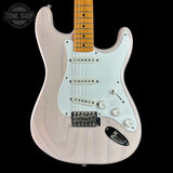 A classic electric guitar with a pale pinkish-white body, a white pickguard, and a natural maple neck, shown against a solid black background with a Tone Shop watermark in the top left corner.