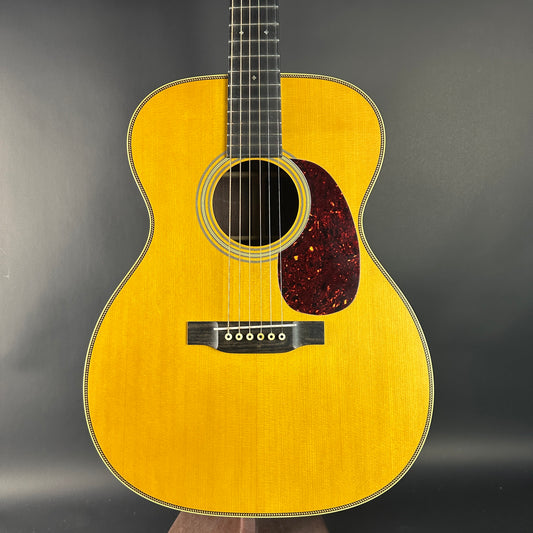 Acoustic guitar with a wooden finish on a dark background