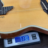 Guitar on a digital scale displaying weight