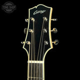 Close-up of a guitar headstock with 'Collings' branding on a black background.