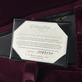 A black presentation box containing a white Certificate of Authenticity for a C.F.