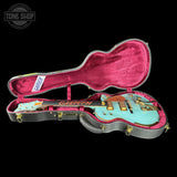Gibson Les Paul guitar in a pink case with 'Tone Shop' logo.