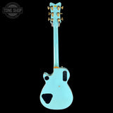 Light blue electric guitar on a black background with 'Tone Shop' logo.