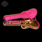 Gibson Les Paul guitar in a pink case with 'Tone Shop' logo.